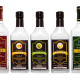 A clean, sophisticated product shot showcasing the Taro vodka and Five Fingers gin lineup, highlighting the elegant bottle design and tropical flavor variants. Perfect lighting emphasizes the premium positioning of these local spirits.