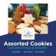 Festive arrangement of classic Swiss butter cookies and gingerbread, decorated with holiday sprinkles. The mix of shapes and textures creates a playful holiday composition against evergreen backdrop.
